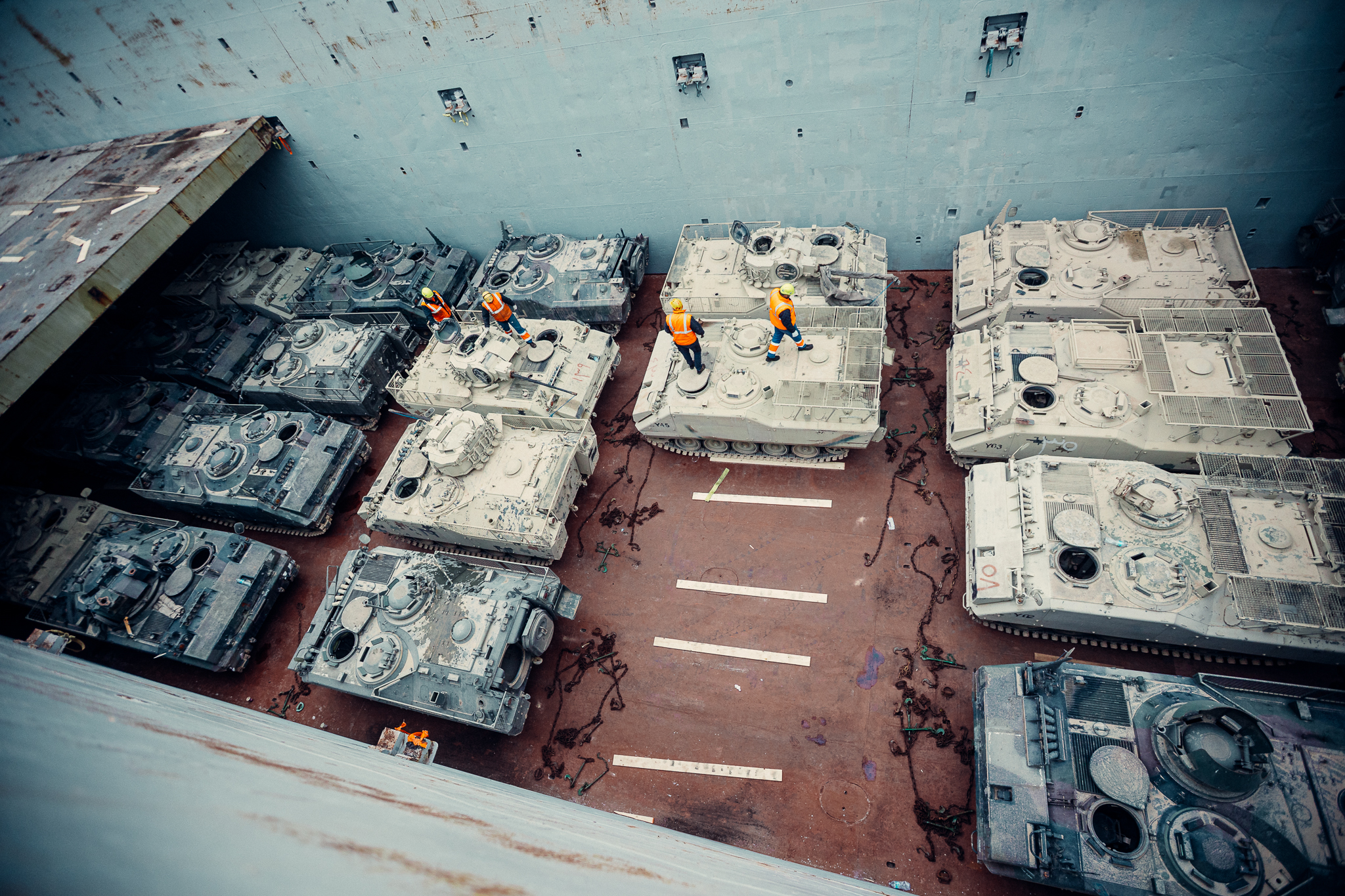 Military vehicles loaded aboard a cargo vessel